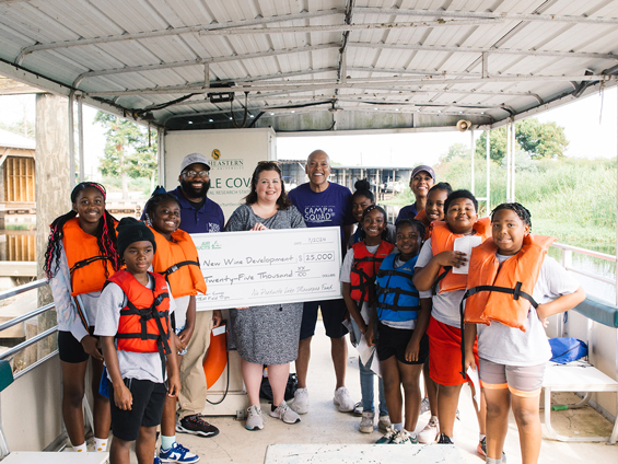 Campers from New Wine Christian Fellowship and representatives from Turtle Cove Research Station pose with check from Air Products’ Lake Maurepas Community Fund 